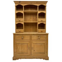 Solid pine dresser, raised plate rack fitted with small drawers over two drawers and double cupboard, plinth base