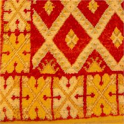 Moroccan Berber hand knotted runner, the red and orange ground woven with an all over lattice of lozenge motifs enclosing small geometric devices, within narrow patterned borders, finished with fringe to one end