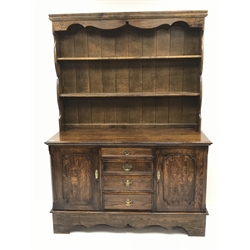  18th century style medium oak dresser, two tier plate rack, four graduating drawers flanked by two cupboards, shaped plinth base, W137cm, H190cm, D54cm  