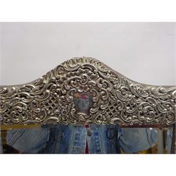 Early 20th century continental silver mounted dressing table top mirror, of rectangular form, the frame embossed with vacant reserve, lattice work, flower heads and C scrolls, with easel style support verso, unmarked but tests as silver, overall H49.5cm W31.5cm