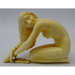  Art Deco carved ivory figure of a nude kneeling with arms outstretched, attributed to Ferdinand Preiss (1882 - 1943) H6.5cm, L9cm and 19th century turned bone handle, originally from sword stick (2)  