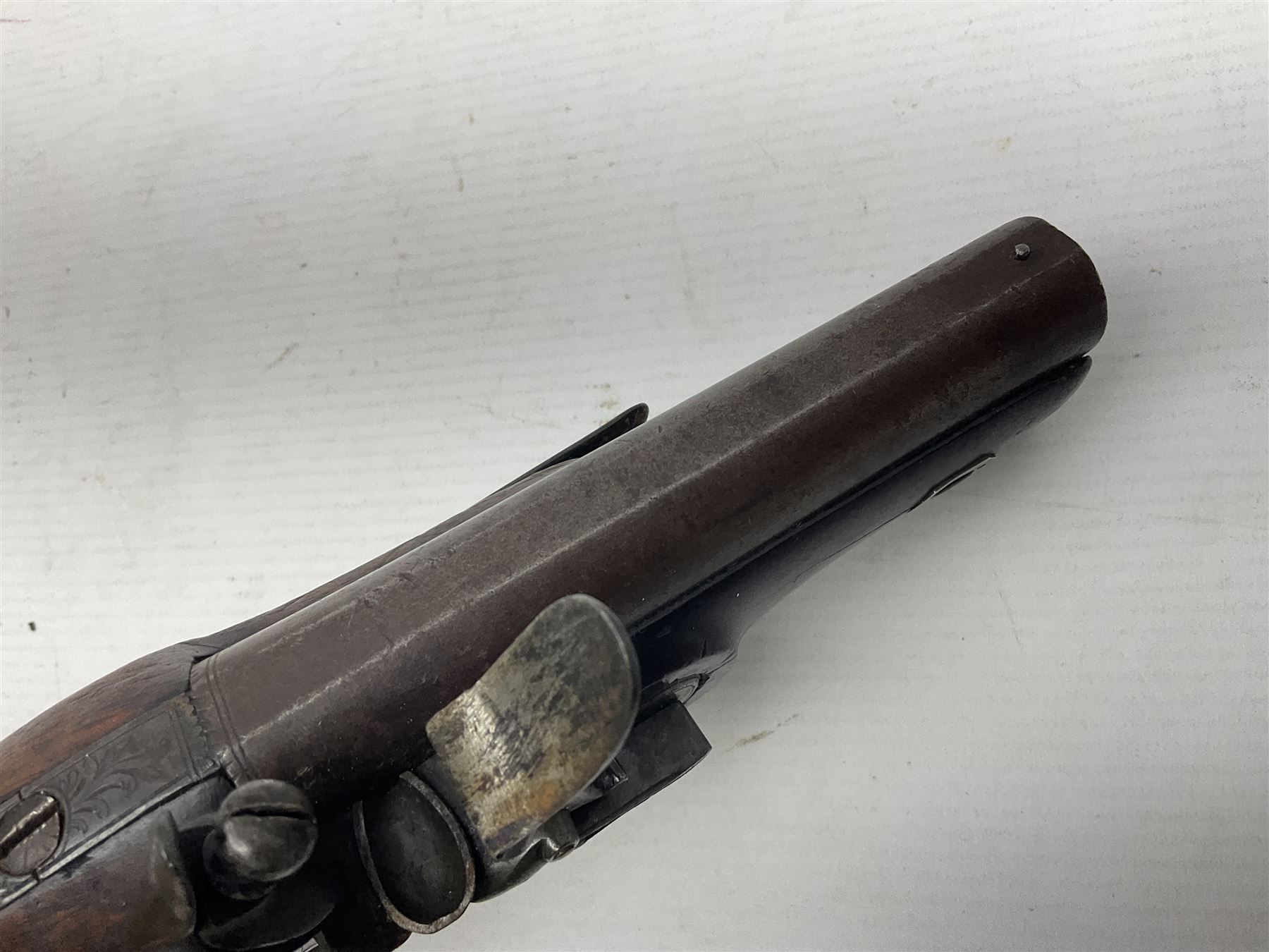 Early 19th century Wm. Hollis flintlock belt or pocket pistol, approximately 20 bore, the 10cm barrel with ram rod under, engraved lock plate with maker's name and roller frizzen, engraved trigger guard with pineapple finial and walnut stock with chequered grip L25cm overall