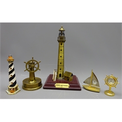  Unusual brass cigar cutter in the form of a six-spoke Ship's Wheel on base, a model of Cape Hatteras Lghthouse, a Lightjouse trinket box and two Nautical themed clocks (5)  