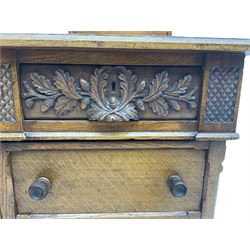 Late 19th century heavily carved oak twin pedestal desk, rectangular top with two raised trinket or correspondence structures each with three drawers, rectangular top over three frieze drawers carved with acorn and oak leaf decoration, each pedestal with three drawers with acorn husk shaped handles