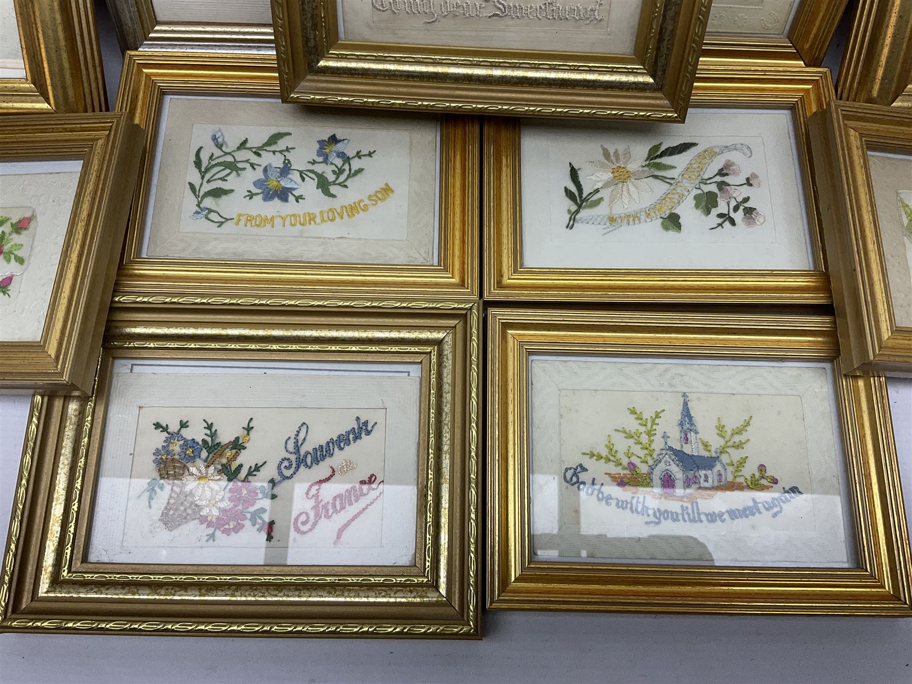 Collection of twenty eight, mostly WWI period embroidered silk greetings cards and postcards, including 'A kiss from France', good luck, sweetheart and Christmas examples, all within modern gilt frames