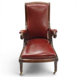 William IV mahogany high-back library reading armchair, arched cresting rail with moulded C-scrolls and bellflowers, the padded arms raised on waisted supports with lappet style carving below scrolled arm terminals, the lower reeded frame raised on splayed supports with brass cups and castors, upholstered in red leather with sprung seat