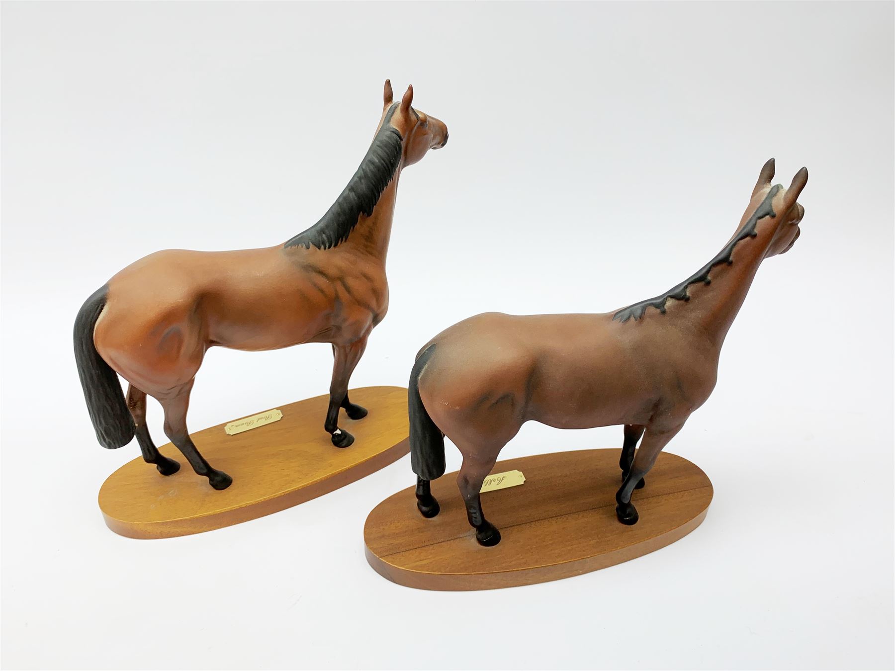 Four Royal Doulton horse figurines, comprising Red Rum, Arkle, and the Winner DA154, and another modelled as a prancing bay horse, largest H32cm. (4). 