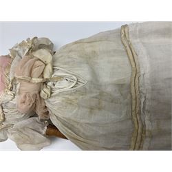 Victorian wax shoulder head doll with pale complexion, applied hair, inset glass eyes and fabric covered jointed body with kid leather lower arms; white linen dress and undergarments H50cm