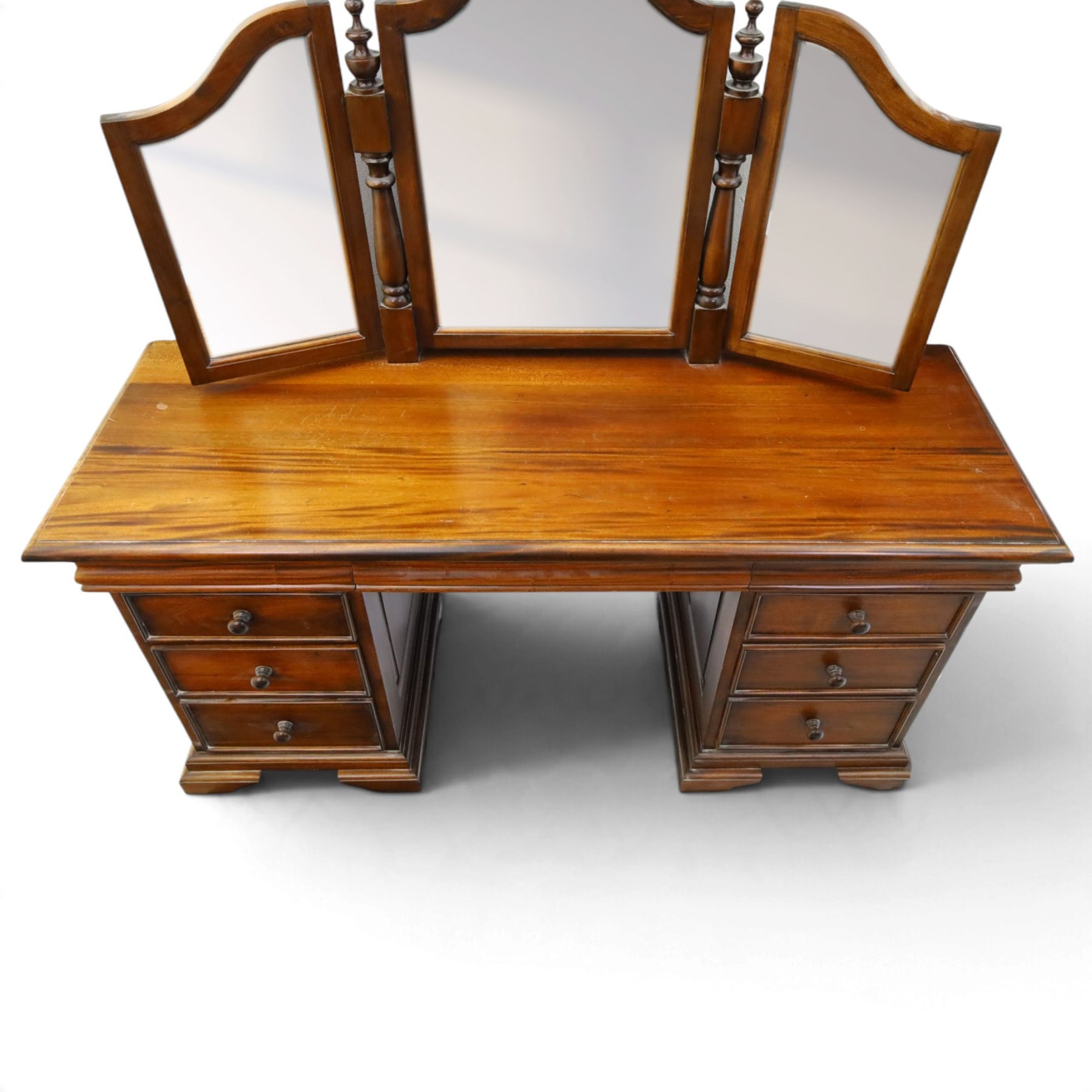 Willis & Gambier - cherrywood dressing table with mirror and stool, three-part mirror on turned uprights with finials, rectangular top above three cushion-moulded frieze drawers, twin pedestals each fitted with three graduated drawers, panelled sides and stepped plinth bases, stool with turned supports and padded seat