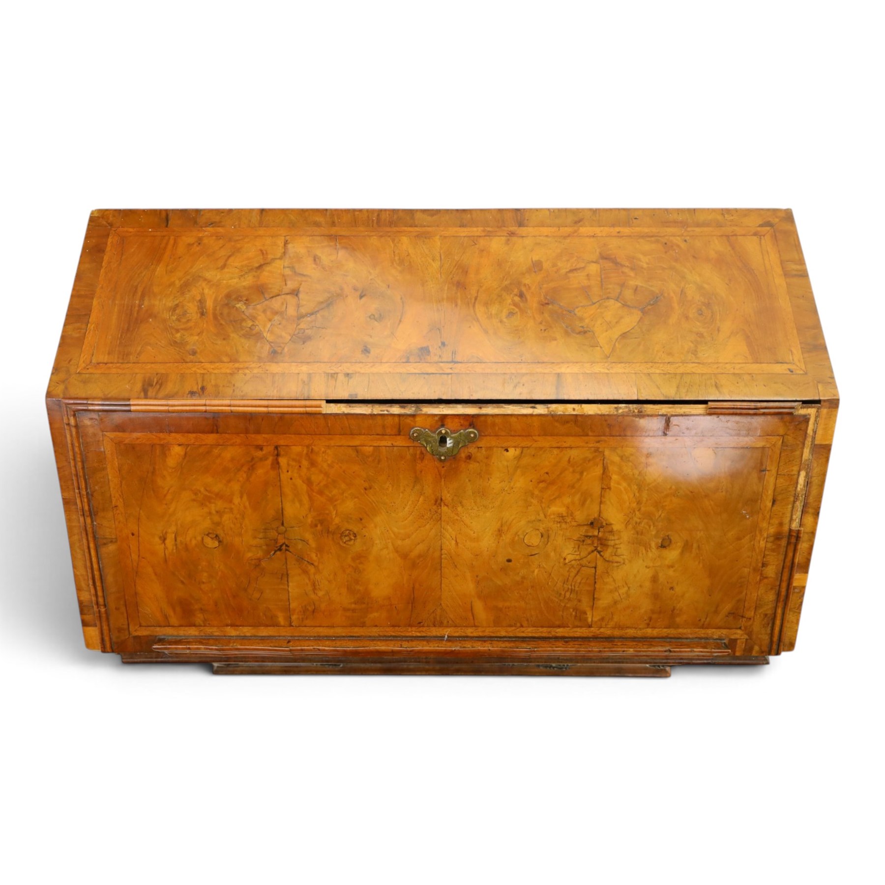 18th century figured walnut bureau, the sloped fall-front enclosing fitted interior with sliding base, pigeon-holes and correspondence drawers with shaped facias, over two short and two long feather-banded drawers with pressed brass handle plates, on bracket feet