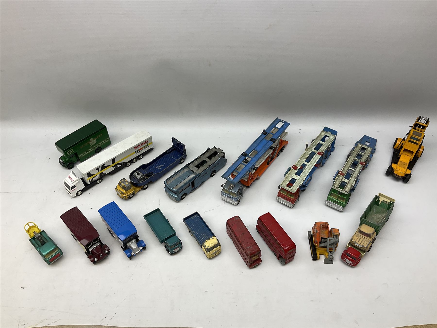 Corgi - eighteen unboxed and playworn/repainted die-cast commercial vehicles including Commer 5-Ton Wagon with drop-side trailer and two other 5-Ton wagons, Dodge Key Fargo, Jeep FC-150, two London Routemaster buses, Carrimore Trideck Transporter, two Carrimore Mark IV Transporters, Carrimore Low Loader, Ecurie Ecosse Racing Car Transporter etc (18)
