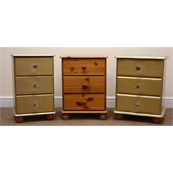  Two graduating pine bedside chests, gold painted finish, bun feet (W46cm, H59cm, D38cm max) and a similar pine bedside chest, three drawers (W44cm, H59cm, D39cm)  