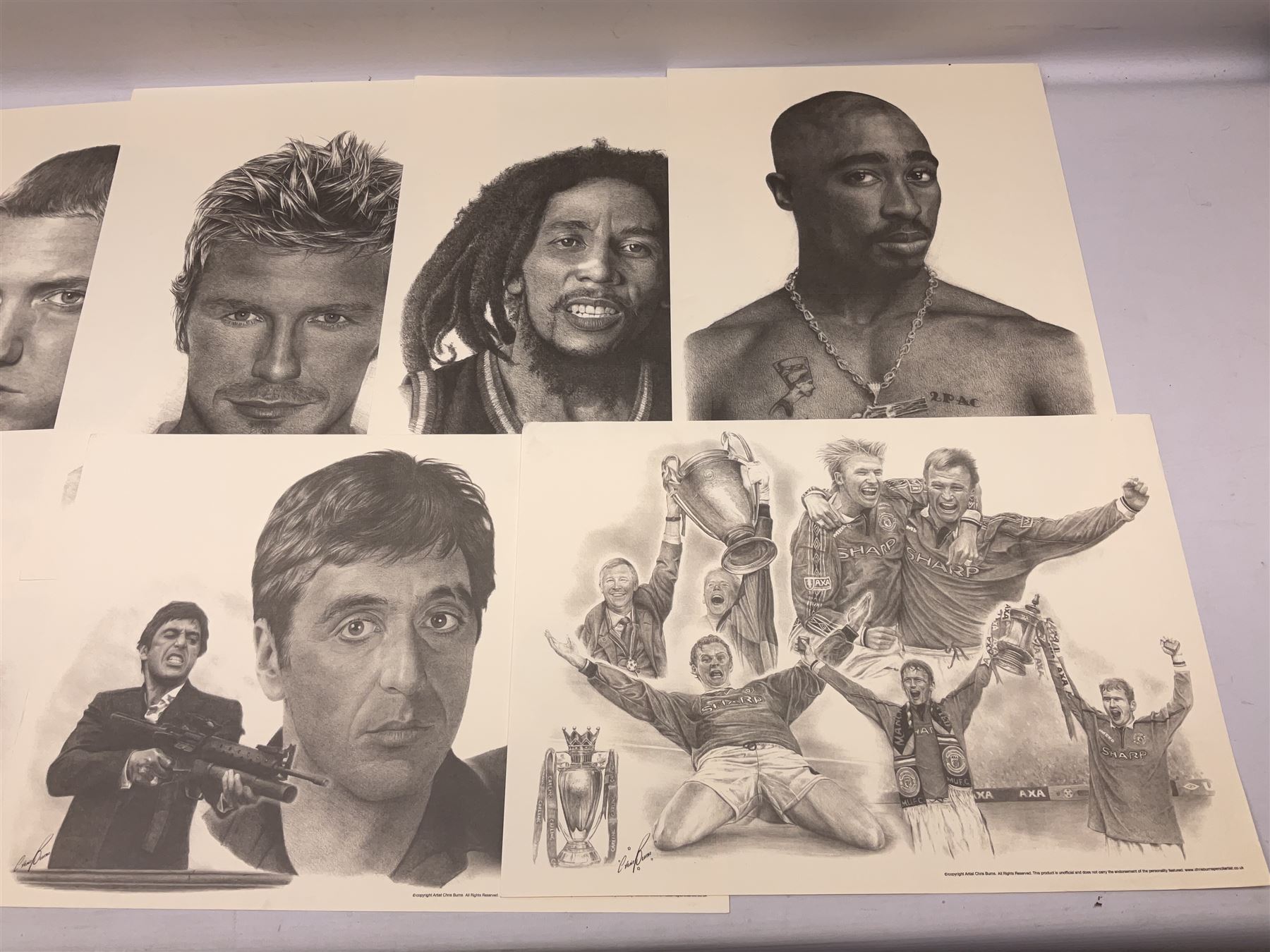After Chris Burns, twenty-one unframed monochrome prints of pop, film and sports stars including The Beatles, John Lennon, Jimi Hendrix, Madonna, Marilyn Monroe, John Wayne, Bruce Lee, Audrey Hepburn, David Beckham, Manchester United etc. 29.5 x 42cm; some card mounted; and 1935 Silver Jubilee Daily Mail newspaper