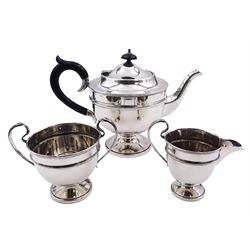 1930's silver three piece tea service, comprising teapot with ebonised handle and finial, twin handled sucrier, and milk jug,  each of circular form with girdle, upon a circular pedestal foot, hallmarked Viner's Ltd, Sheffield 1932 and 1934, including handle teapot H16cm, approximate gross weight 26.68 ozt (829.7 grams)