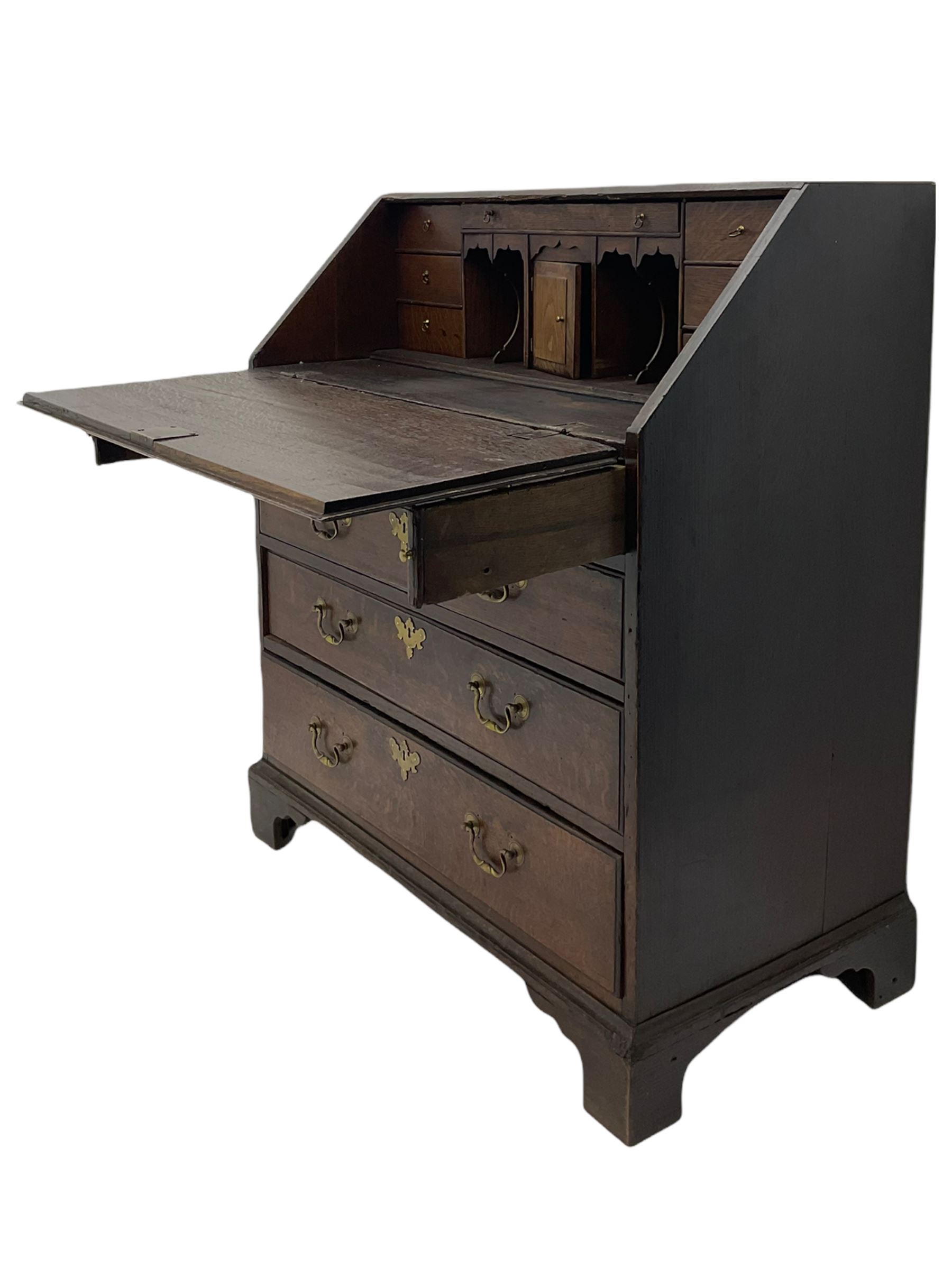 Georgian oak bureau, fall front enclosing fitted interior, four long graduating drawers, on bracket feet