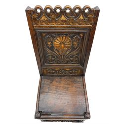Pair 17th century carved oak and fruitwood inlaid hall chairs, the pierced cresting rail over panelled back carved with scrolled foliate and flower head, boarded seat on turned supports joined by stretchers, dated 1629