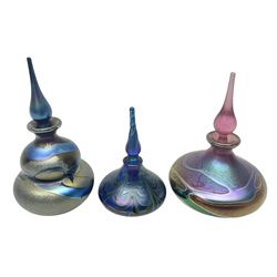 Three Okra scent bottles, the first example of gourd form, decorated with iridescent threads in blues, greens and browns, another of squat form with iridescent designs in purples, pinks and golds and one other, largest H14cm