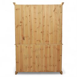 Late 20th century pine kitchen dresser, the upper section with open shelves and tongue and groove back, over a triple cupboard base with three drawers, turned wooden knobs throughout