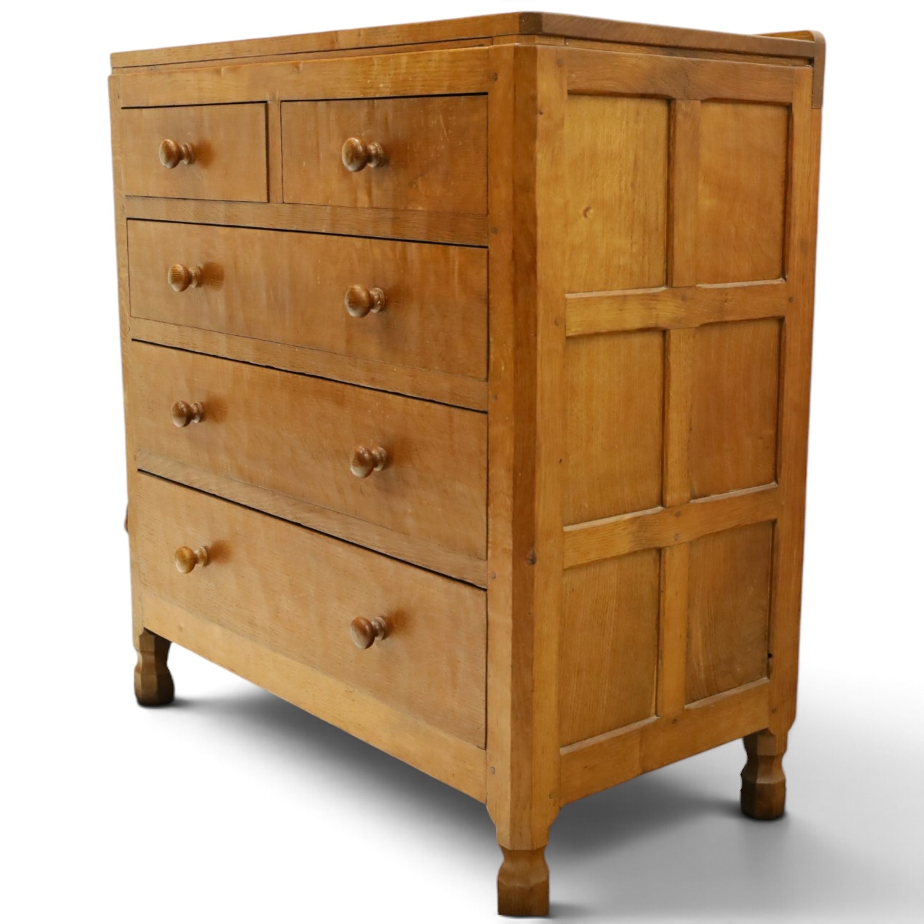 Mouseman - early-to-mid 20th century adzed and panelled oak chest, raised back over rectangular adzed top with canted corners, fitted with two short over three long drawers with turned knob handles, raised on octagonal feet, with carved mouse signature, by the workshop of Robert Thompson of Kilburn