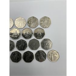 Twenty-four Queen Elizabeth II Great British commemorative fifty pence coins from circulation, including Paddington Bear, Peter Rabbit and Benjamin Bunny