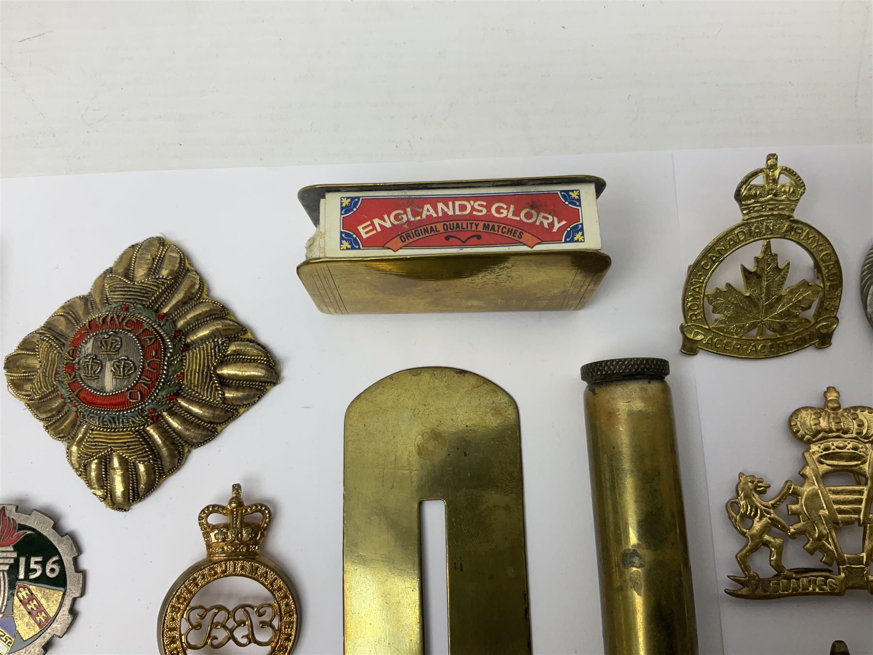 Collection of approximately sixty worldwide medals, metal badges, belt buckles, cloth badges, trench art, brass button stick etc