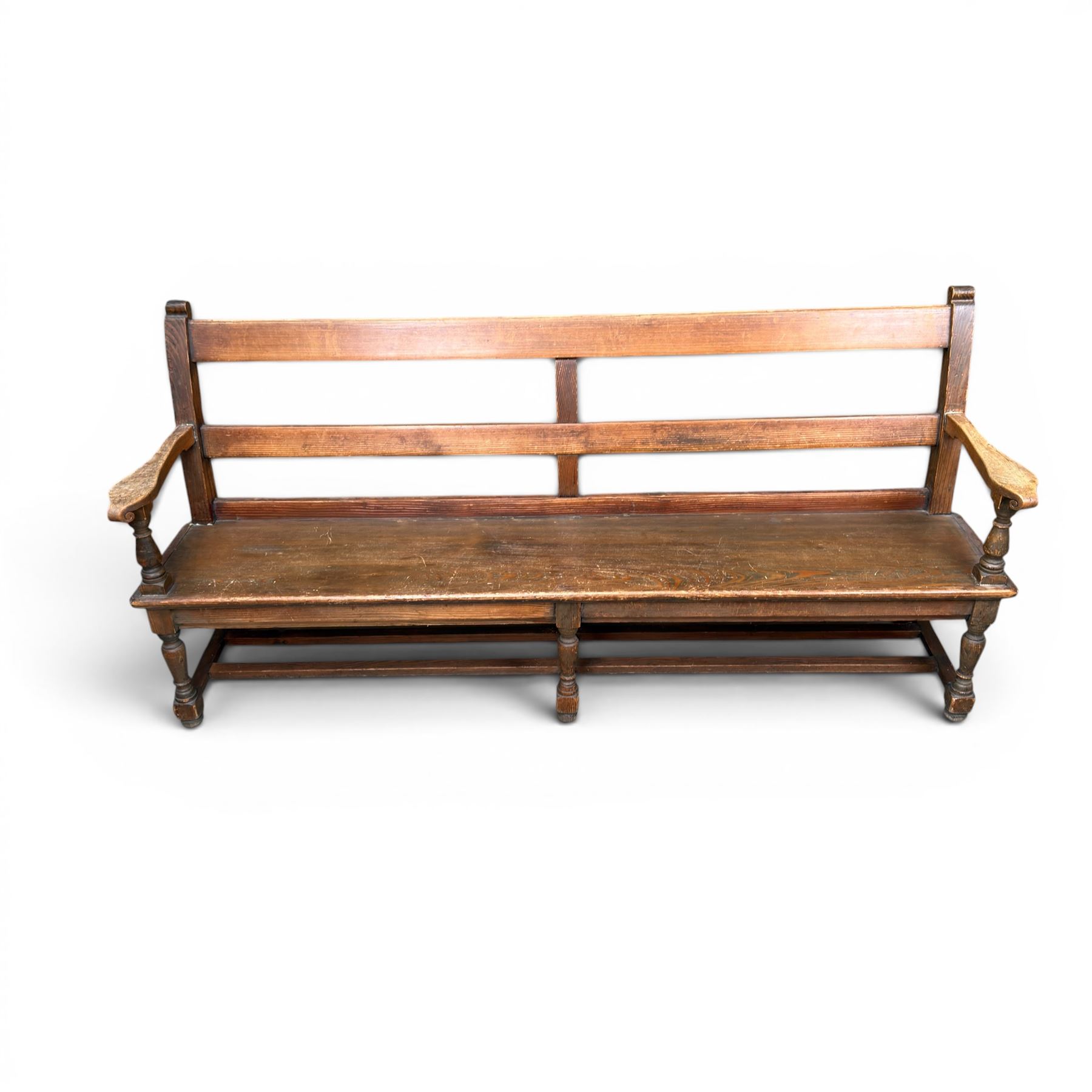 Early 20th century pine and oak bench seat, stained pine rail back frame with shaped oak arms