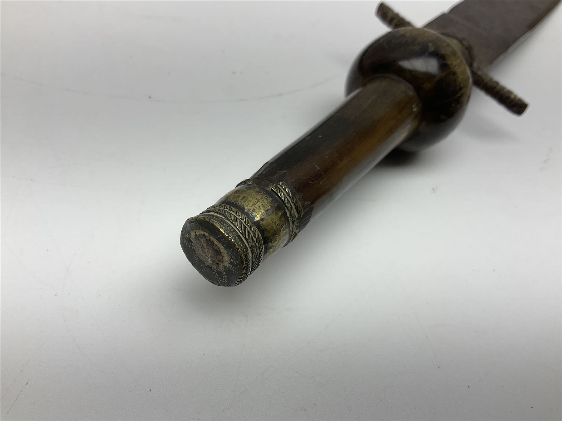 19th century continental folding knife with 15.5cm single edged blade, the pierced brass and iron handle with remains of horn grips L21.5cm overall closed; turned horn handled knife with foliate engraved blade; battlefield relic German 1884/98 knife bayonet; iron spear head; leather covered swagger stick; and two-piece gun cleaning rod