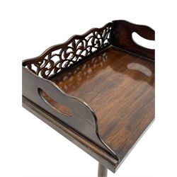 Regency style hardwood book tray on stand, the tray with pierced fretwork back and handle pierced sides, turned tapered column carved with foliate baluster, on triangular platform carved with scrolls, turned and lobe carved feet