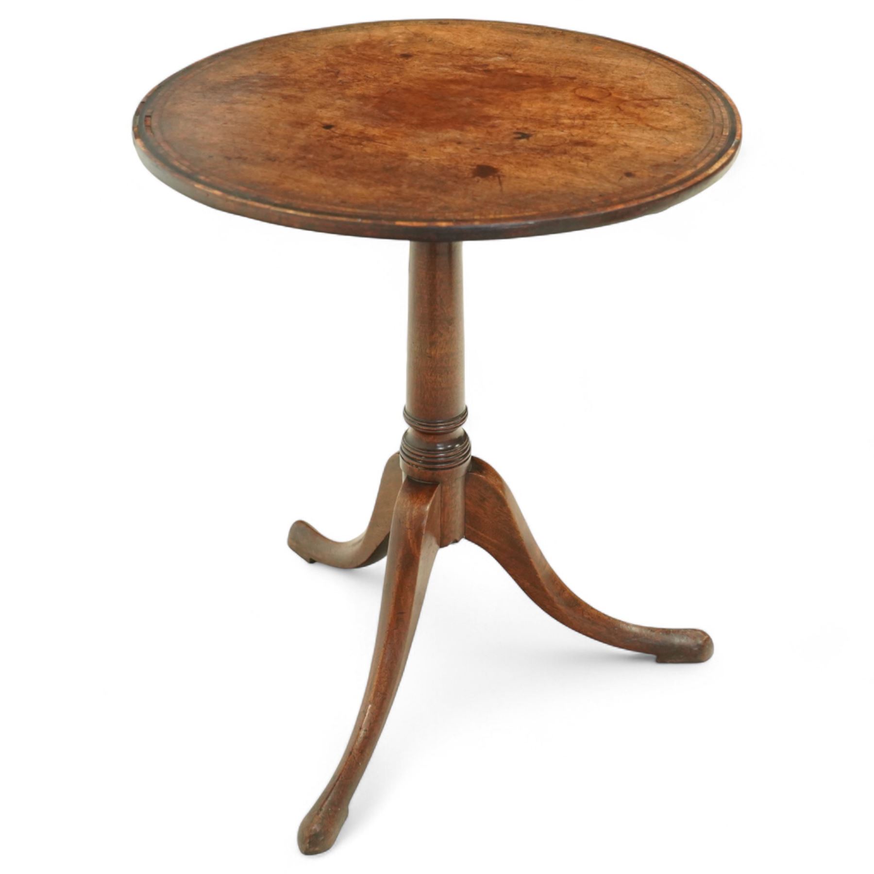 George III mahogany tilt-top tripod table, the circular top with moulded edge and inlaid edge, tilting on an iron catch above a ring-turned column, raised on three outswept legs terminating in pad feet