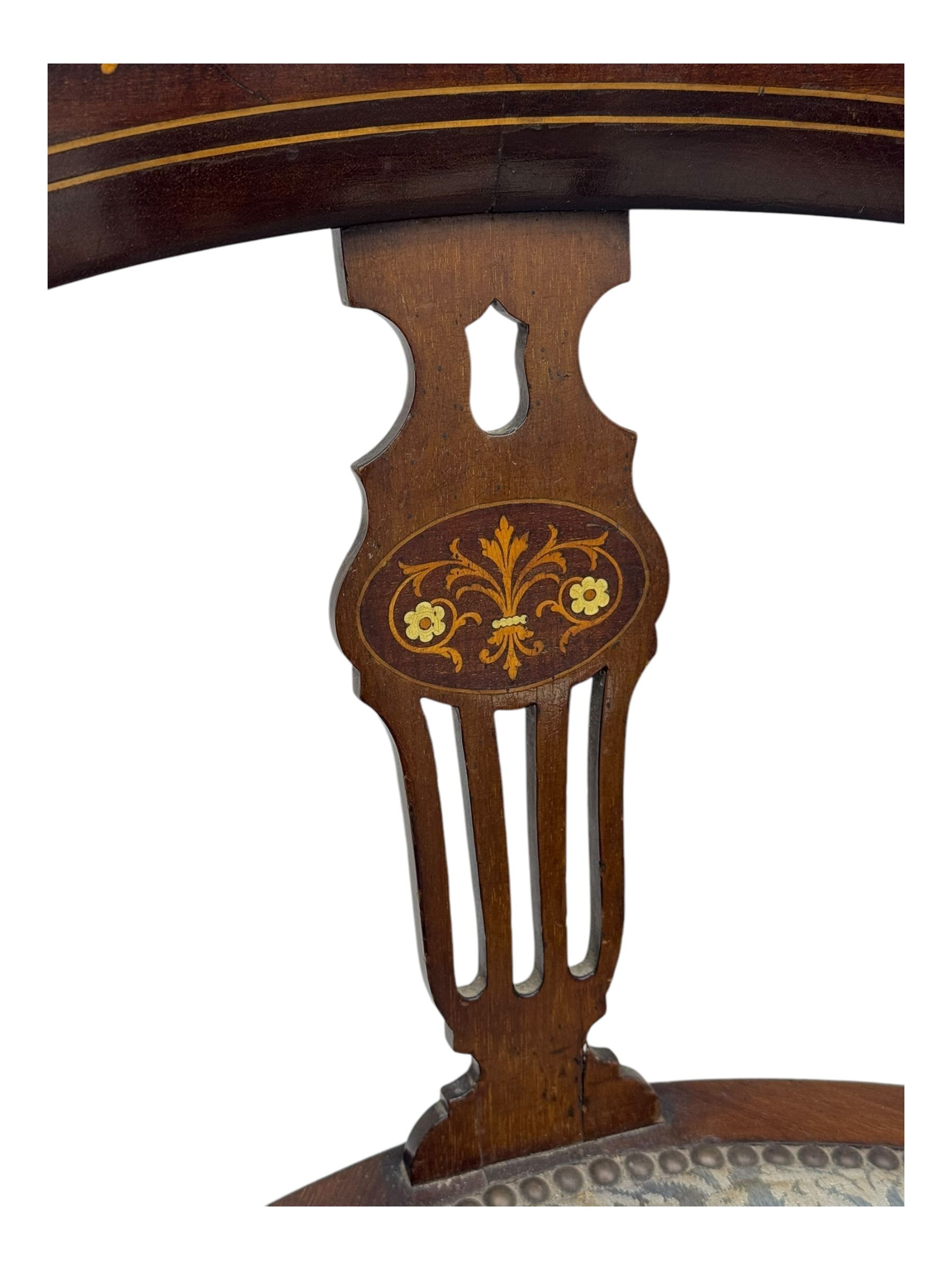 Edwardian inlaid mahogany corner chair, curved arms on shaped splat supports inlaid with satinwood, on turned supports (W60cm, H75cm); Edwardian inlaid mahogany tub-shaped armchair, the cresting rail inlaid with scrolling acanthus leaves and flower heads, on square tapering supports with spade feet (W58cm, H80cm)
