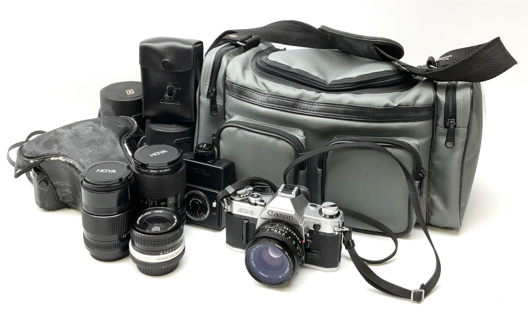 Canon AE1 camera, 'no. 4403757', fitted with Canon 'FD 50mm 1:1.8' lens, Hoya 'HMC Wide-Auto f24mm 1:2.8' lens and various other lenses and camera accessories, housed in a soft carry bag