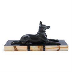 French Art Deco spelter figure of a recumbent dog on marble and onyx plinth, H14cm, L30cm