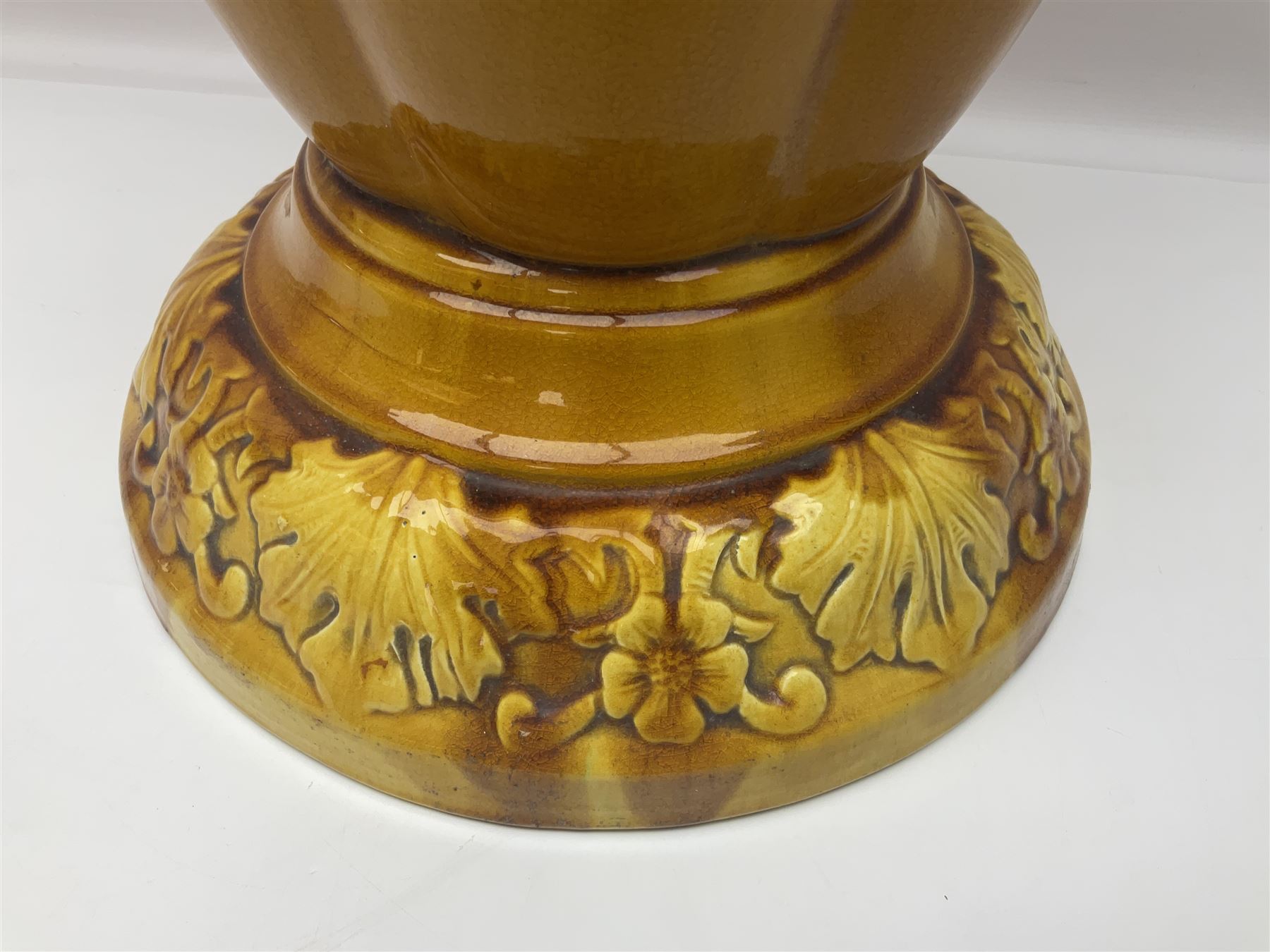 Bretby Jardiniere and stand, with foliate and foliage decoration with a red and yellow ground, impressed mark beneath H94cm