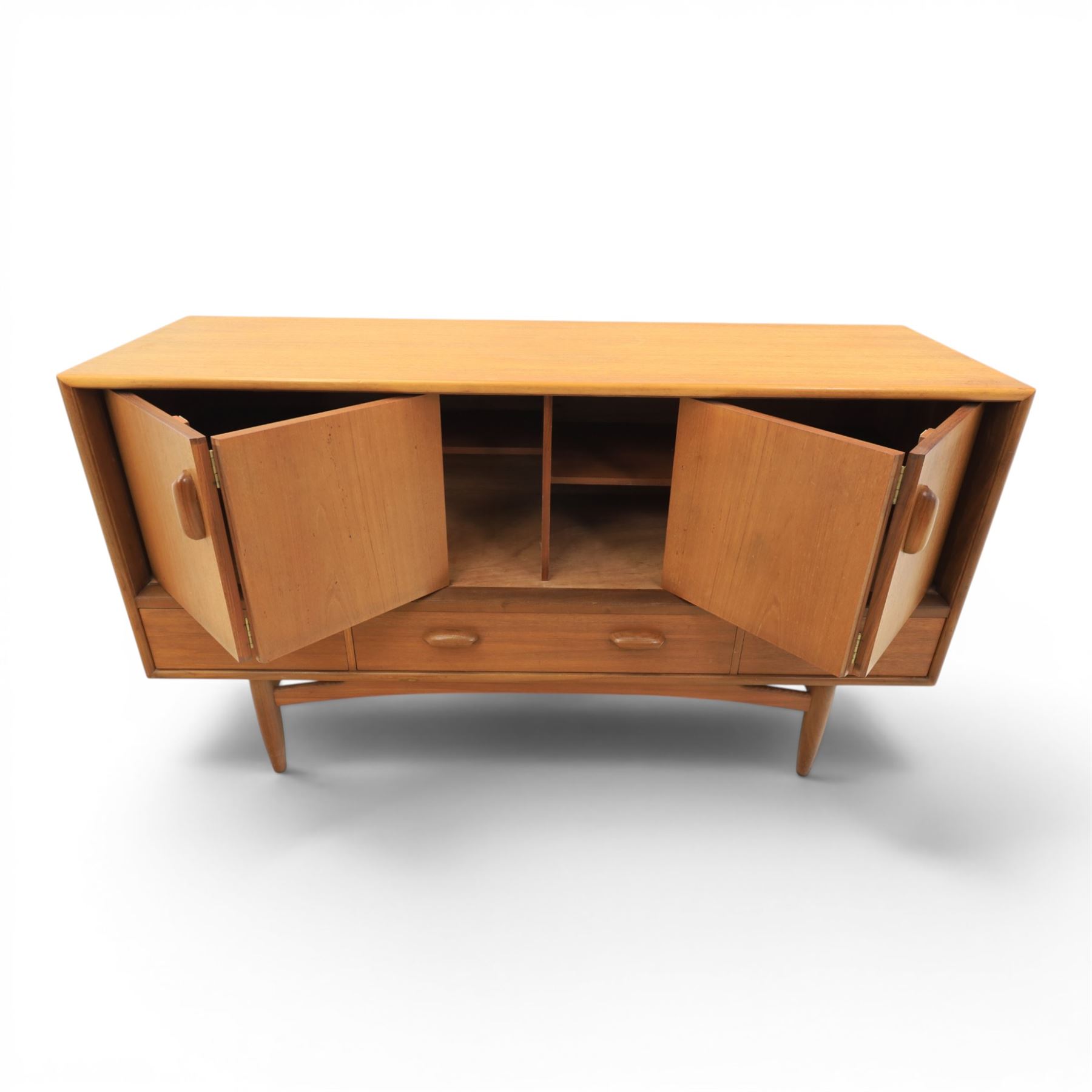 G-Plan - 'Brasilia' teak sideboard, with rectangular top above two concertina doors, above four drawers raised on cylindrical supports