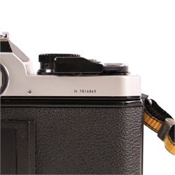 Nikon FM2 film camera body serial no. 7814849 with a Sigma 24mm lens serial no.5083190, camera user manual and Nikon carrying case