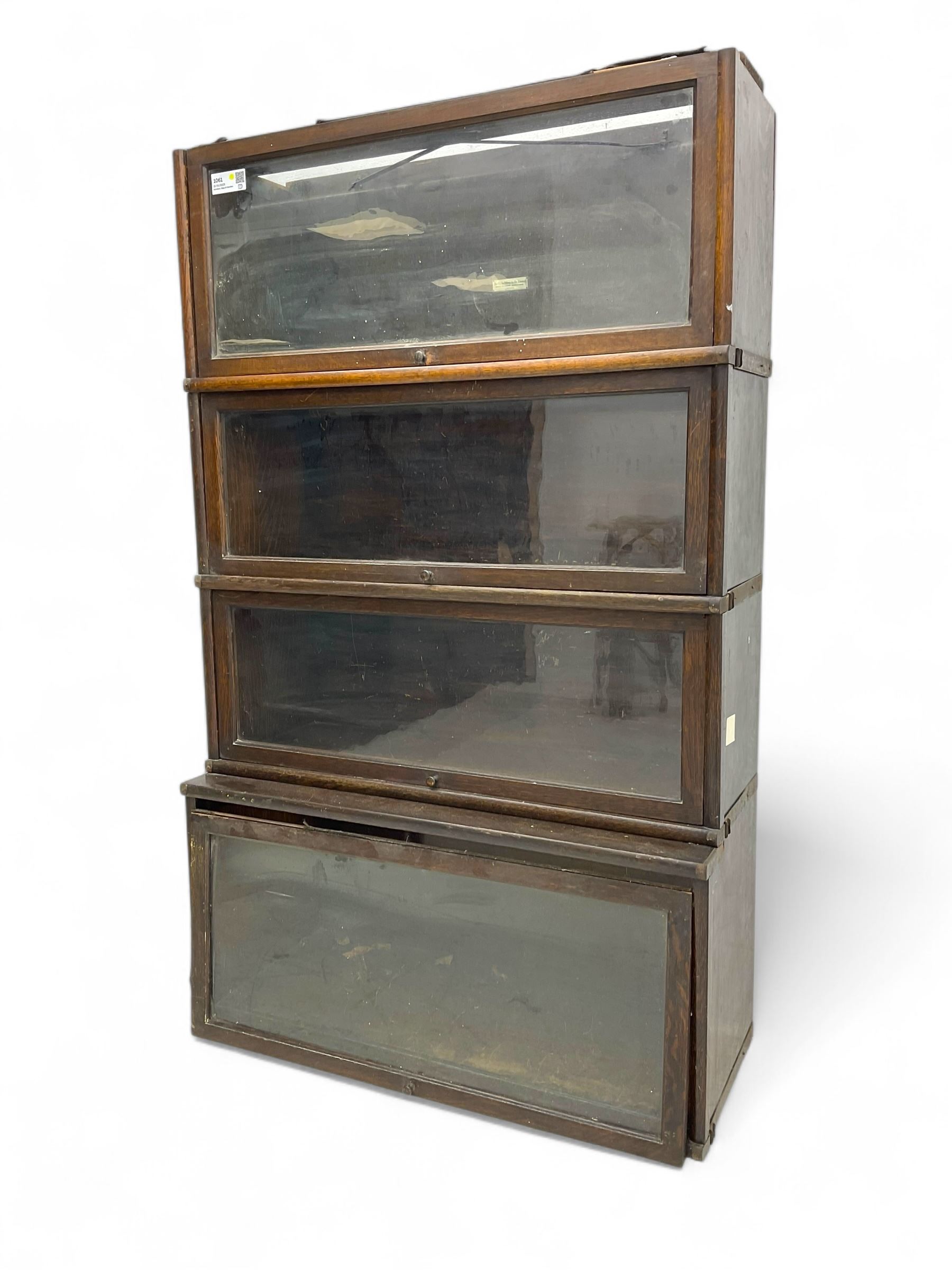 Globe Wernicke - early 20th century oak four-tier stacking library bookcase, four glazed sections enclosed by hinged and sliding doors