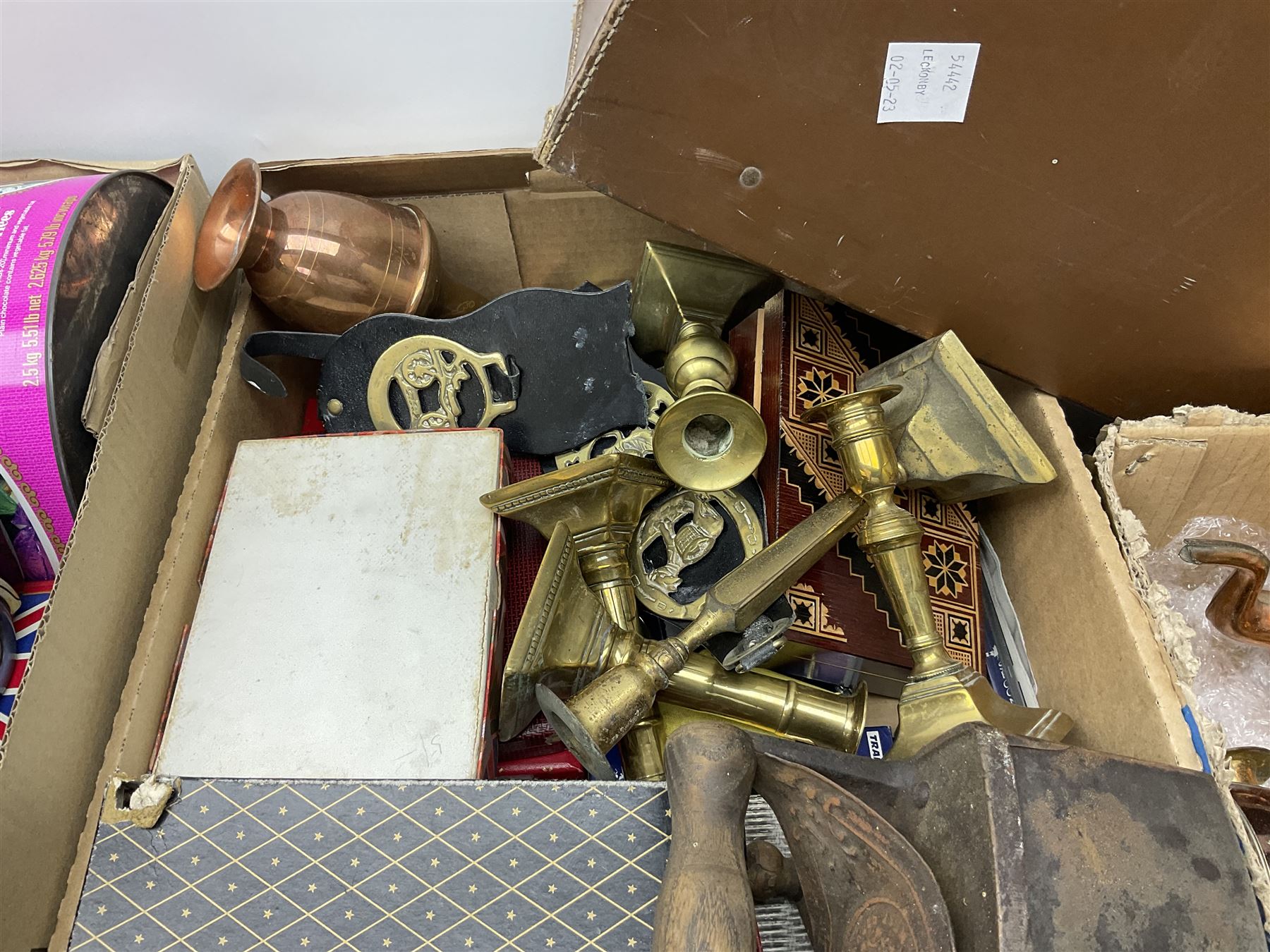 Collection of silver plated cased cutlery including part canteens and butter knives, together with other metal ware including J&J Siddons iron, horse brasses and a copper kettle, 1970s children's annuals including Beano, two handbags and three suitcases, vintage tins etc, in four boxes 