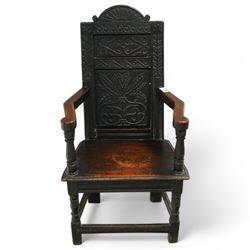 17th century and later carved oak Wainscot chair, the panelled back decorated with carved foliage and scrolls, the frame decorated with trailing guilloche and foliate motifs, moulded seat over turned supports united by stretchers 