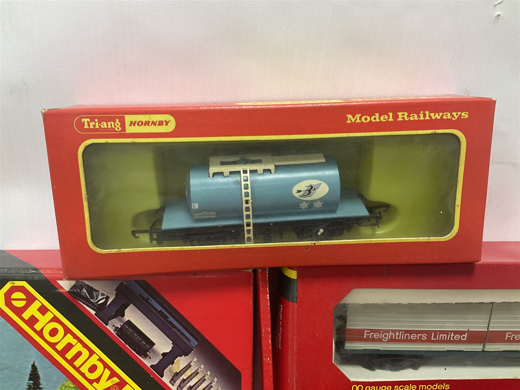 Hornby/Tri-Ang ‘00’ gauge - fifteen goods wagons to include freightliners with containers, ore wagons, closed vans etc; together with R404 Operating ore wagon set; all boxed (16) 