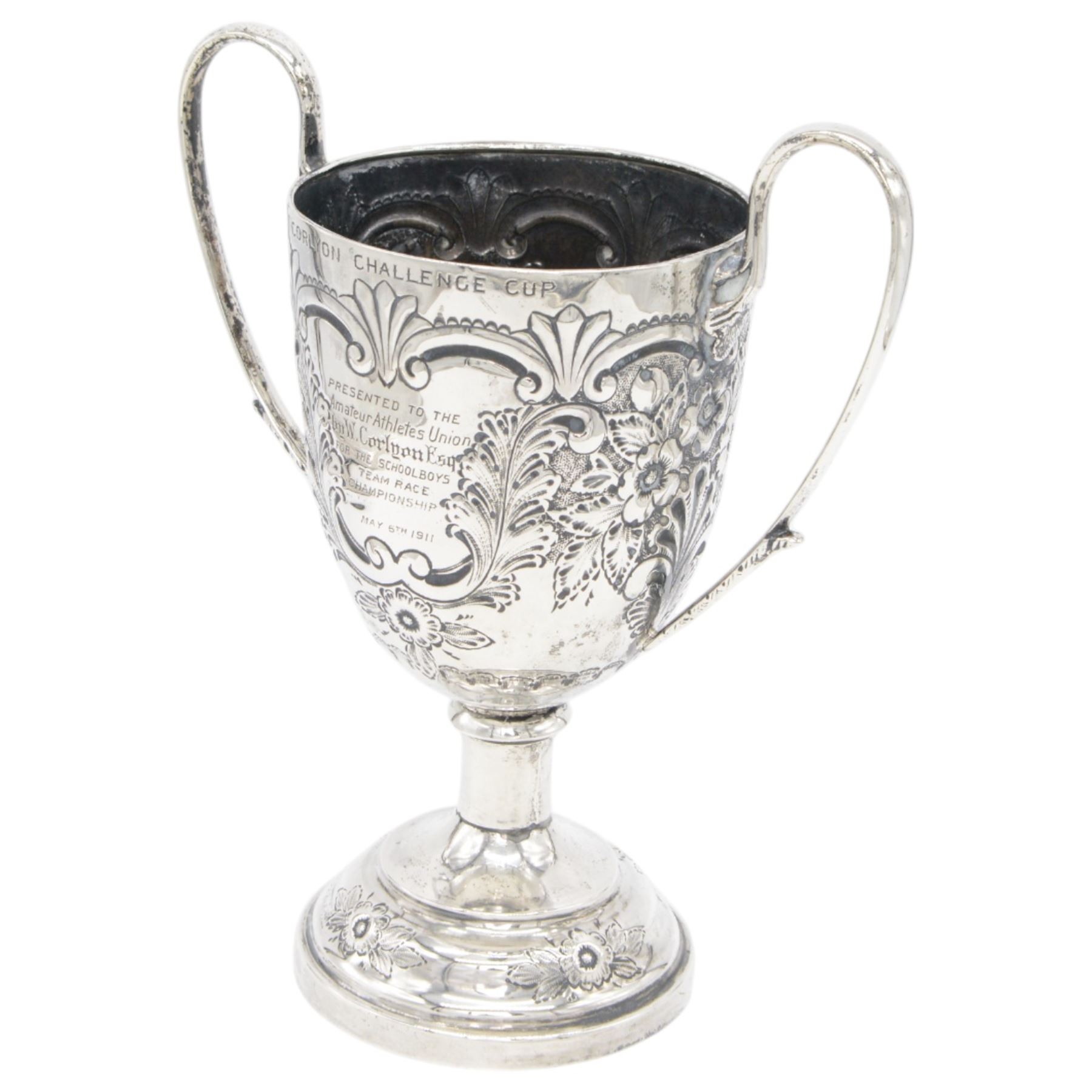 Edwardian silver twin handled trophy, engraved with presentation engraving and embossed with floral and foliate decoration to body, upon a domed circular weighted base, hallmarked 	Hammond, Creake & Co (Saint Arnaud Creake), Sheffield 1902, H22cm