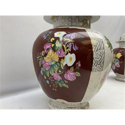 Pair of continental lidded vases, of bulbous form painted with alternate panels of lovers in a garden and floral spray on dark red ground, with scrolled gilt borders, both with painted marks beneath, H43cm, together with an floral encrusted jug