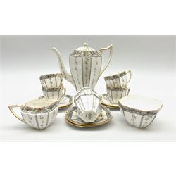 An Art Deco Shelley Queen Anne shape coffee set for six decorated in the Fruit Border pattern, pattern number 1563, comprising coffee pot, cream jug, open sucrier, teacups and saucers. 