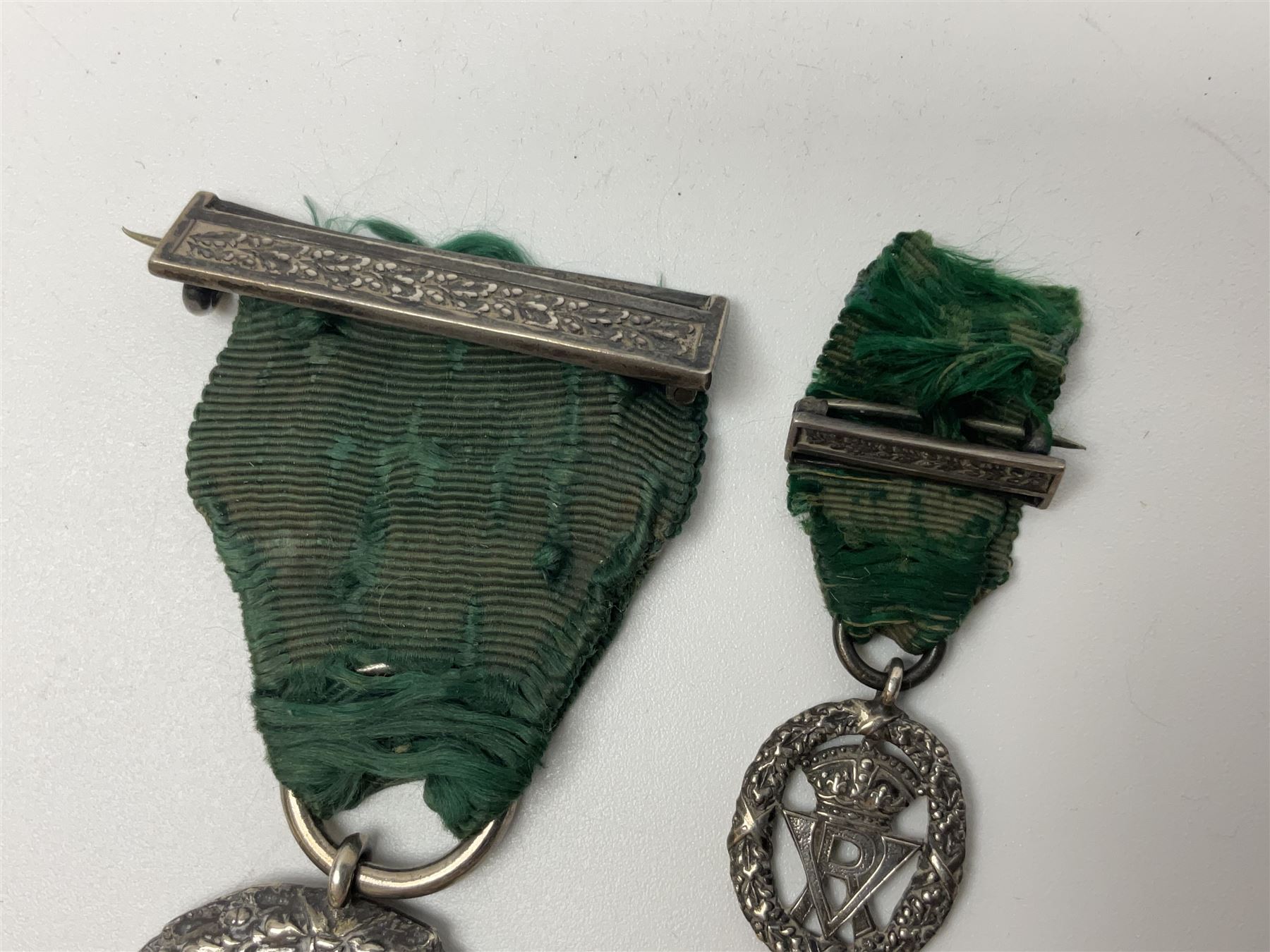 Victoria Volunteer Officers’ Decoration, V.R. cypher, hallmarked silver London 1892, with integral top riband bar and ribbon, unnamed; the matching miniature; and Victoria 'For Long Service in the Volunteer Force' miniature medal with ribbon in original case (3)