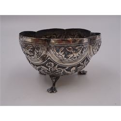 Continental silver bowl, of circular lobed form, repousse decorated with tribal and hunting scenes, upon three claw feet, unmarked but testing as 800 silver, H5cm, together with Chinese silver purse, of domed rectangular form, with ornate repousse decoration, depicting flowers, instruments, birds etc, with lobed wire wrapped handle, with Chinese character marks beneath, testing 650 silver,  including handle H11cm, and two base metal miniature animals