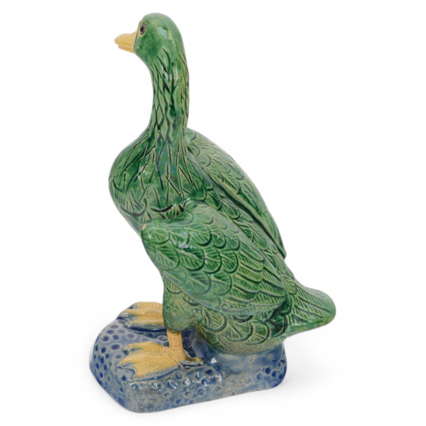 Pair of 20th century Chinese standing ducks, standing on a mottled base, H20cm