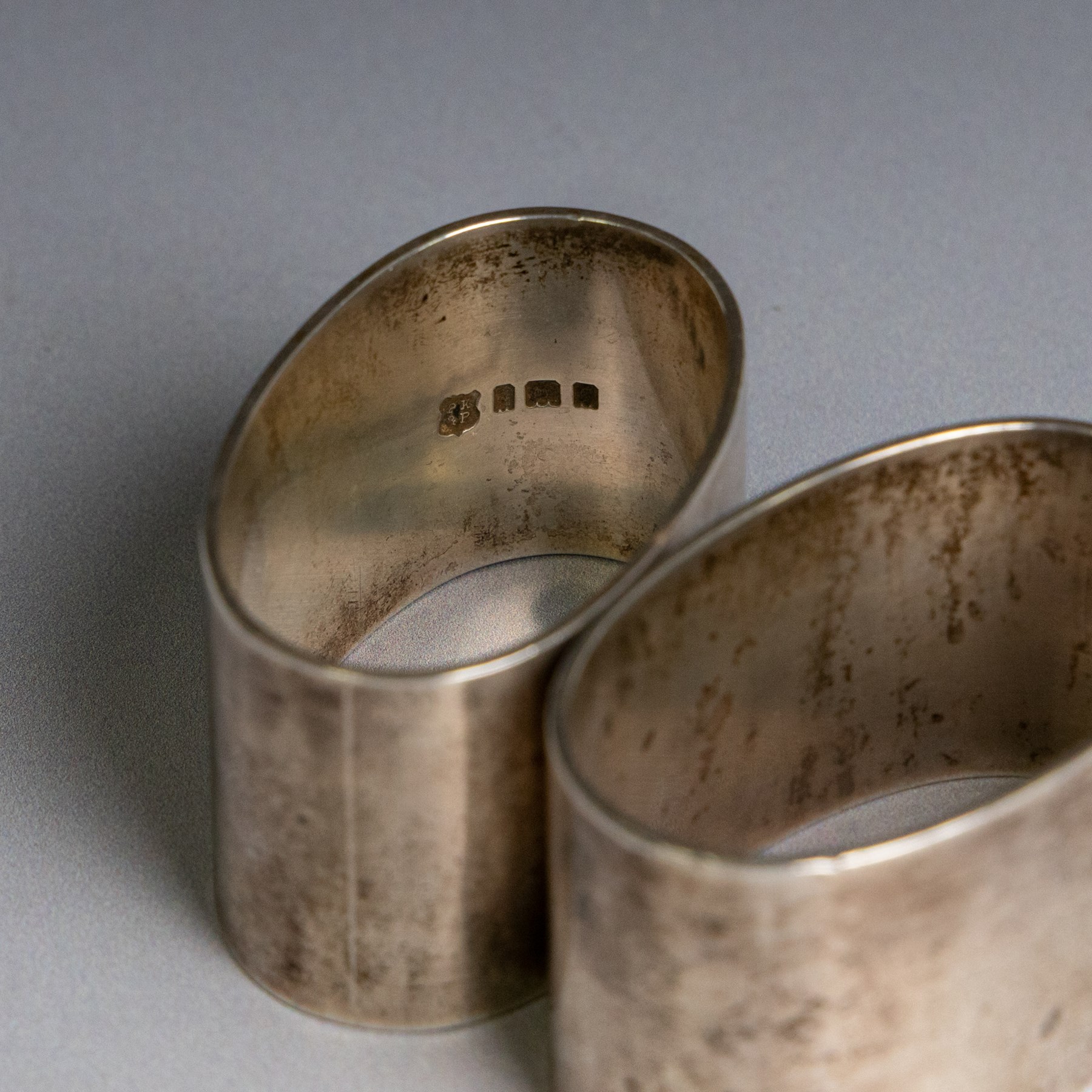 Two silver napkin rings, of oval form with engraved initials, both hallmarked