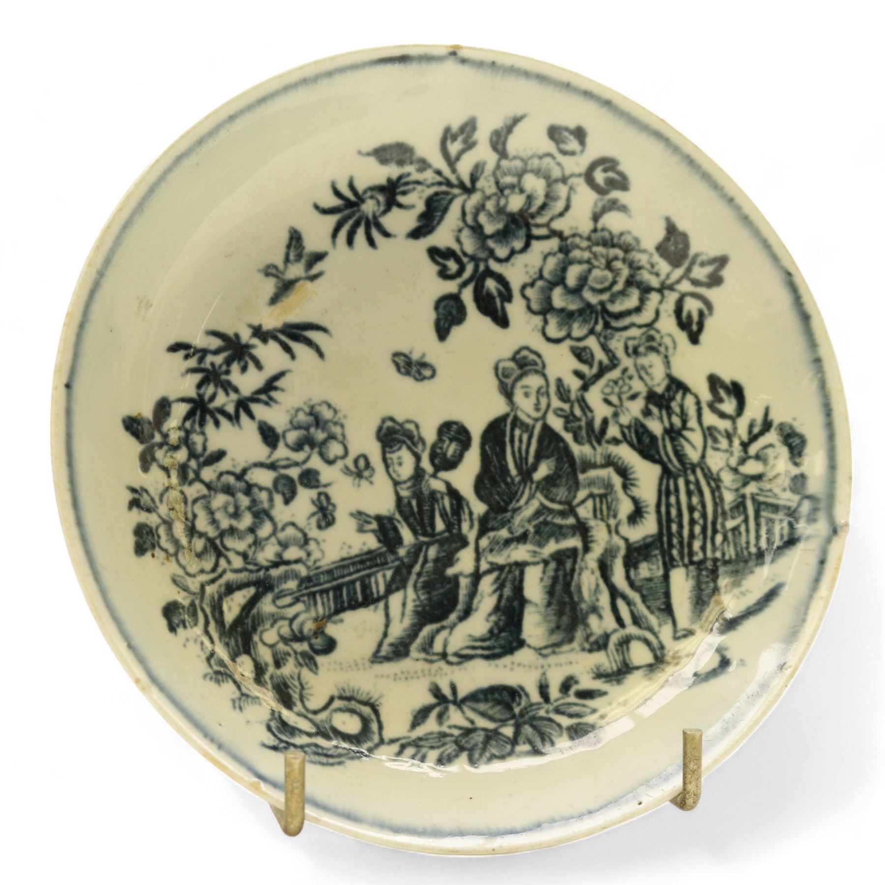 Chinese tea bowl, the enamel decoration depicting floral sprigs within a gilt and blue boarder, with a crowned shield to the centre, together with another bowl and a saucer