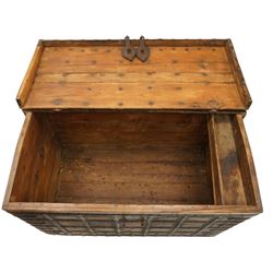 Large 19th century North Indian teak and wrought iron-bound dowry chest, probably Rajasthani, the shallow domed plank lid secured with broad iron straps above a lattice-carved frieze and grid of riveted iron bands, with twin shaped hasps, side carrying handles and fitted interior till, on bracket feet