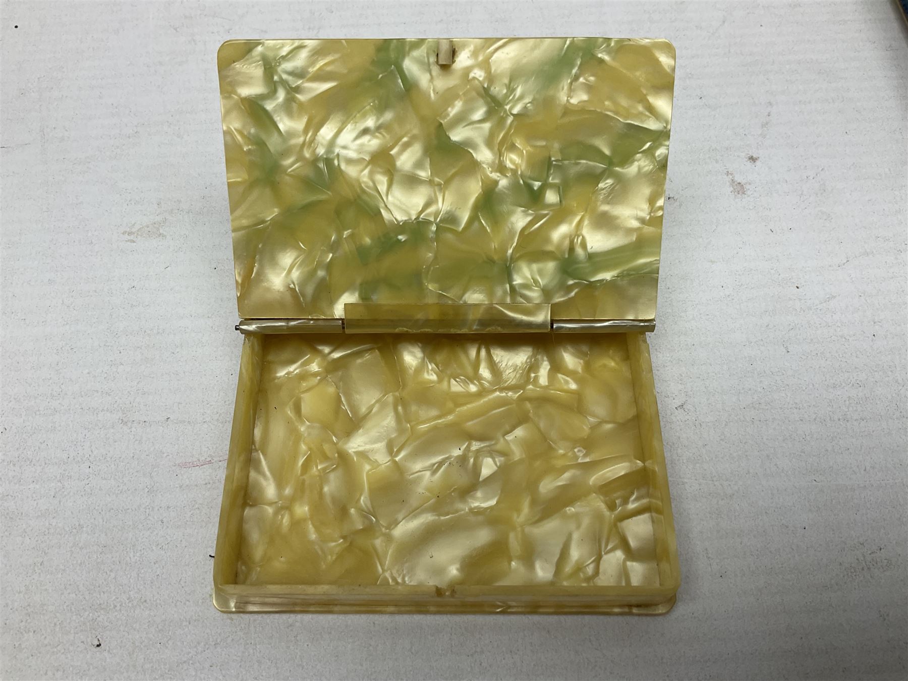 Mother of pearl and abalone inlaid card case, with central diamond shaped panel engraved with foliate decoration, together with a simulated mother of pearl card case of book form with green sun rays to cover, and simulated wood effect cigarette case with hinged lid with diamante style banding, largest L10cm