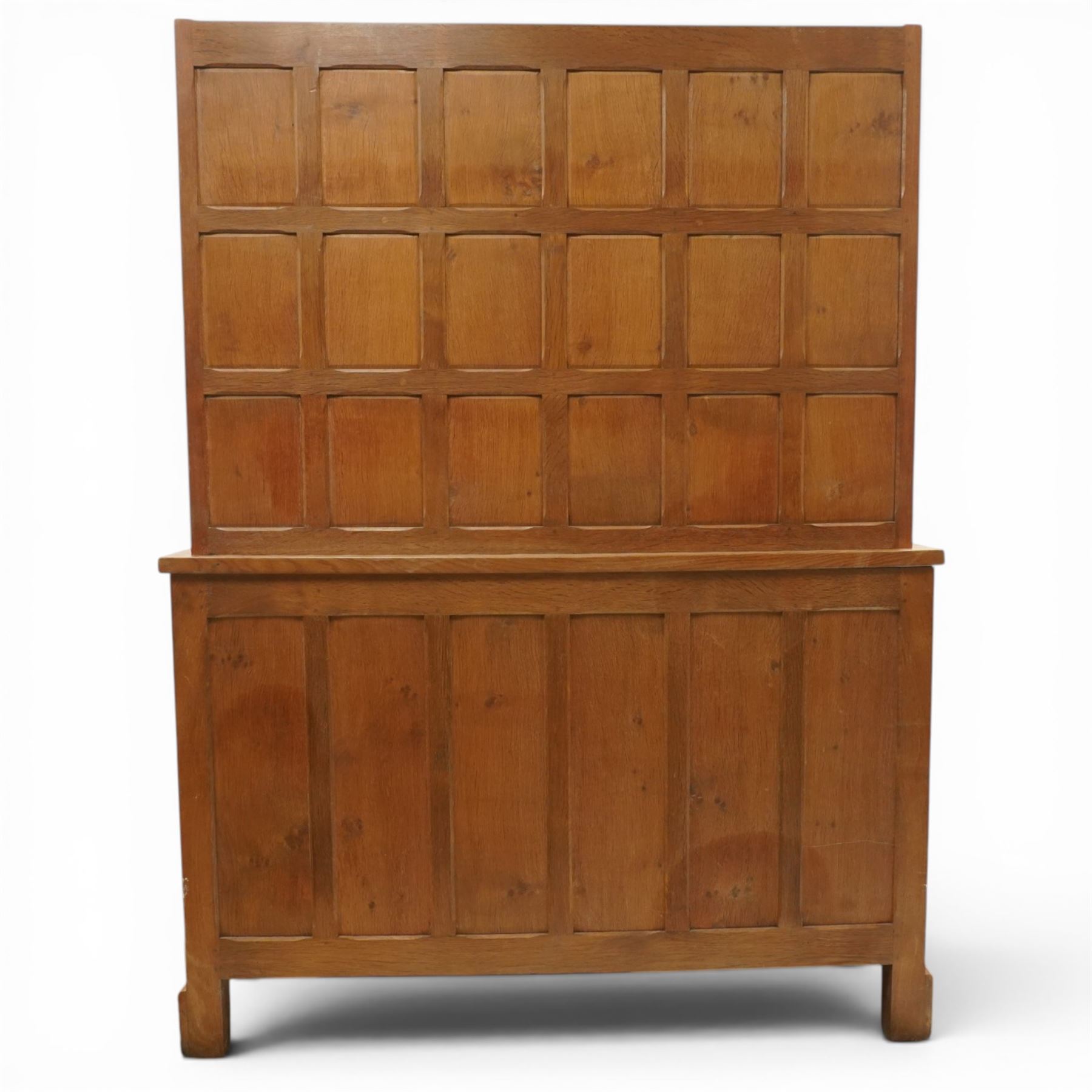 Cat and Mouseman - adzed oak dresser and plate rack, plate rack with two delf rack, panelled back and shaped uprights, above a base with two short drawers and turned wooden handles, panelled cupboard doors and sides, raised on a plinth base, with carved Cat and Mouseman signature, by Lyndon Hammell of Harmby